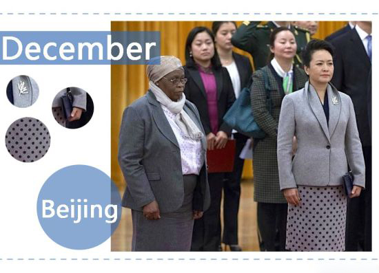 2014年12月,南非总统雅各布•祖马来华进行国事访问。彭麻麻身着灰色正装外套和一件圆点图案的及膝裙,胸针也十分别致,展现出中国第一夫人的优雅风范。 In December 2014, Peng Liyuan opted for a formal grey jacket and a knee-length polka dot skirt with a chic pin when the South African President Jacob Zuma paid a state visit